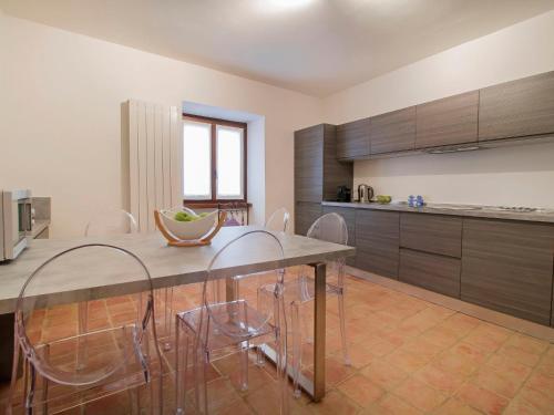 a kitchen with a dining room table and chairs at Holiday Home Cantiniere by Interhome in Tresana