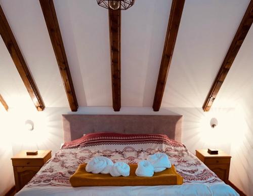 a bedroom with a bed with two towels on it at Lovcen Holiday Home in Cetinje