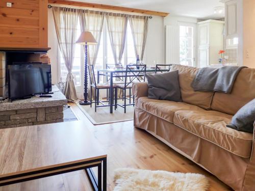 a living room with a couch and a dining room at Apartment Savoie 1 by Interhome in Villars-sur-Ollon