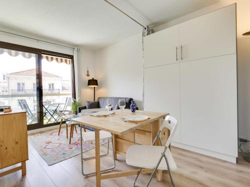 a kitchen and living room with a wooden table and chairs at Studio Sun Beach by Interhome in Arcachon