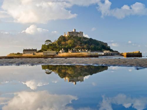 a castle on an island in the water at Holiday Home Pebbles- Marazion by Interhome in Marazion