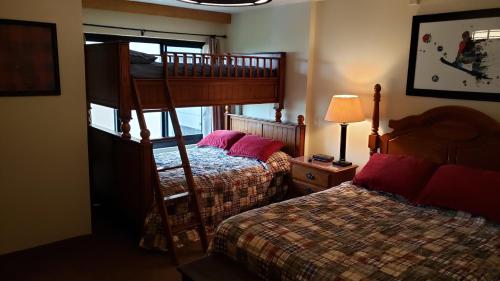 a bedroom with two beds and a bunk bed at Silver Creek Unit 5404, Ski in-out, Pool Hot Tub in Snowshoe