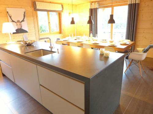 a kitchen with a sink and a counter top at Chalet Chalet Astoria by Interhome in Crans-Montana