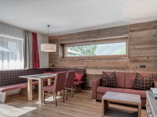 a living room with a table and chairs at Apartment The PEAK-3 by Interhome in Sölden