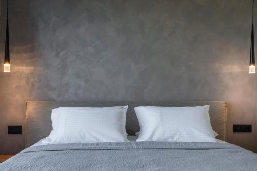 a bed with two white pillows on top of it at Narcissos Villa in Argostoli