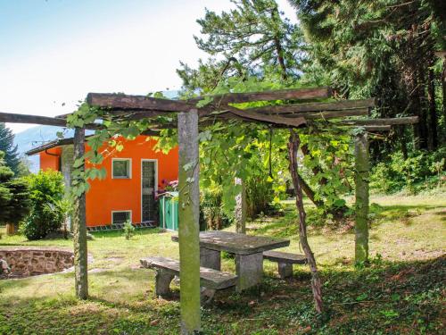 a picnic table and bench in front of a house at Apartment Vista Valle by Interhome in Castro