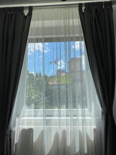 a window with a view of a city at Várárok Vendégház - Miskolc in Miskolc