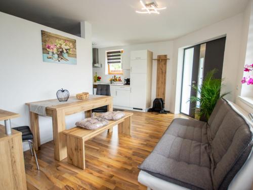 a living room with a table and a couch at Apartment Mundlers Hoamatl Top 1 by Interhome in Oetz