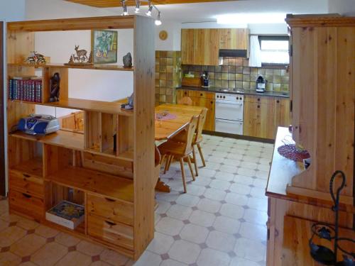 a kitchen with a wooden table and a dining room at Apartment Fricktalerhuus Apt-1 by Interhome in Surava
