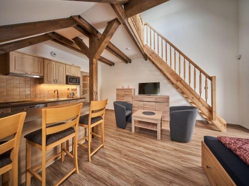 a kitchen and living room with wooden floors and a staircase at Apartment Na Pomezkách by Interhome in Horní Malá Úpa