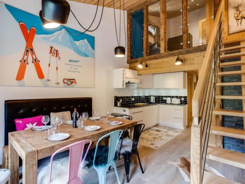 a kitchen and dining room with a wooden table and chairs at Apartment Grand Roc - Val Claret-2 by Interhome in Tignes
