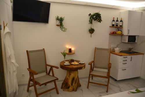 a kitchen with two chairs and a small table and a table with a table at Wellness Vila Bohemia in Prague