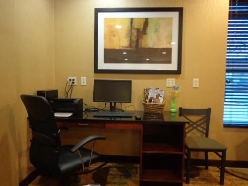 an office with a desk with a computer and a chair at Cobblestone Inn & Suites - Marquette in Marquette