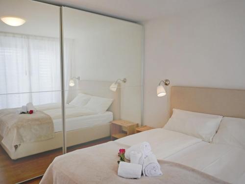 a hotel room with two beds and a mirror at Apartment Chesa San Bastiaun B5 by Interhome in Samedan