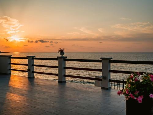 zachód słońca nad oceanem z płotem w obiekcie Holiday Home Santa Maria by Interhome w mieście Caronia Marina