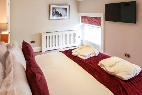 a bedroom with a large bed with two pillows on it at The Borough Lancaster in Lancaster