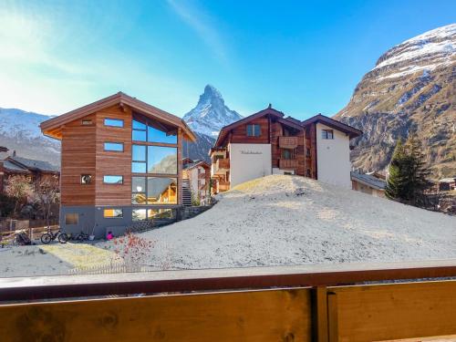 a house in the mountains with a pile of sand at Apartment Bergere-2 by Interhome in Zermatt