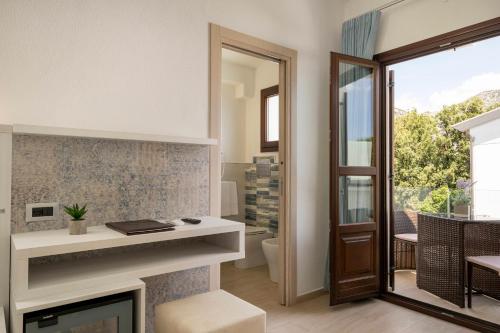 a living room with a fireplace and a mirror at Hotel Ristorante La Conchiglia in Cala Gonone