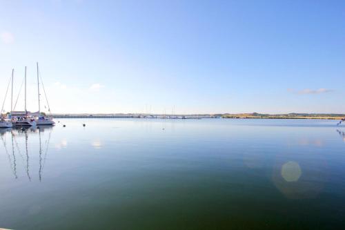 a large body of water with boats in it at Ferienhaus TimpeTe Haus Backbord - Terrasse, Meerblick, Sauna in Gager