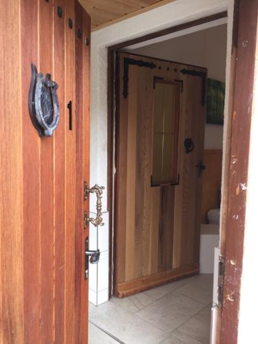 an open door to a bathroom with a clock on it at Natur und Neckarblick bei Heidelberg in Hirschhorn