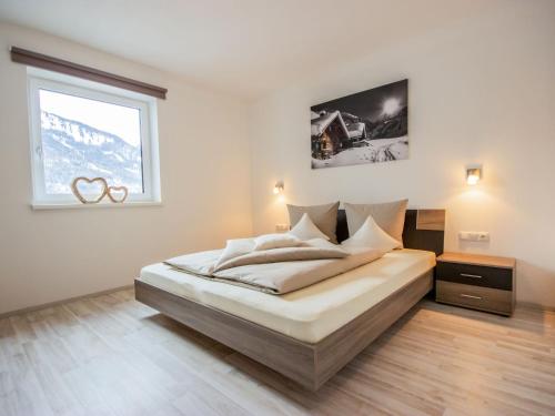 a bedroom with a large bed with a window at Apartment Aileen by Interhome in Fliess