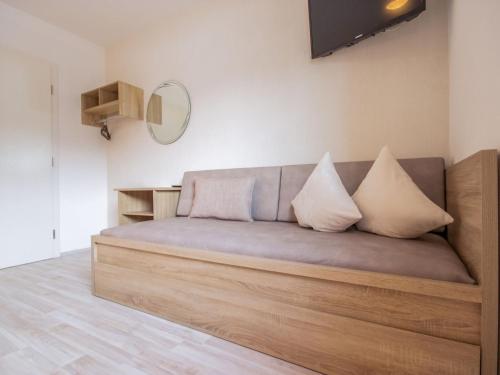 a couch with two pillows on it in a room at Apartment Aileen by Interhome in Fliess