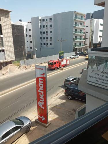 a view of a highway with cars and a red truck at Nalabba in Dakar