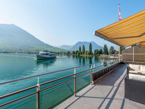 a boat on the water next to a dock at Holiday Home Seestern direkt am See by Interhome in Ennetbürgen