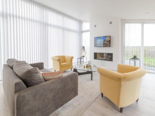 a living room with a couch and two chairs at Holiday Home Water Resort Oosterschelde - nr- 47A by Interhome in Wemeldinge