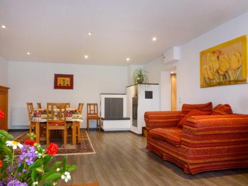 a living room with a couch and a table at Holiday Home Schmetterlingsgarten by Interhome in Hüfingen