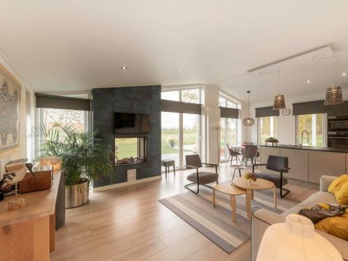 een woonkamer met een bank en een tafel bij Holiday Home Ruisweg 89 by Interhome in Wemeldinge