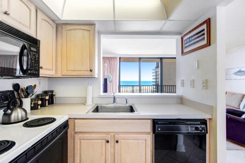 a kitchen with a sink and a view of the ocean at Sea Colony --- 508 Brandywine house in Bethany Beach