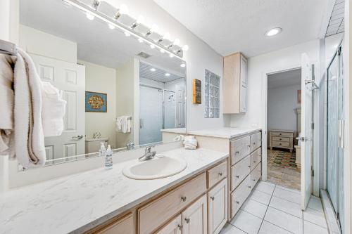 a bathroom with a sink and a large mirror at Sunshine's Holiday in Panama City Beach