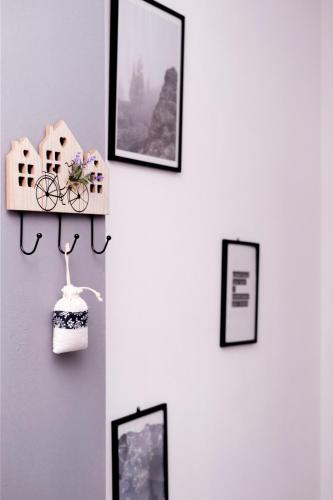 a wall with pictures and a shelf with a bike on it at Ana ROOMS in Ljubuški