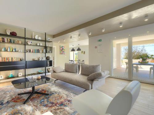 a living room with a couch and a table at Villa Laura by Interhome in Koromačno