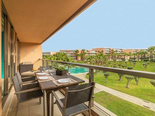 a balcony with a table and chairs and a view at Apartment Salgados Beach & Golf by Interhome in Galé