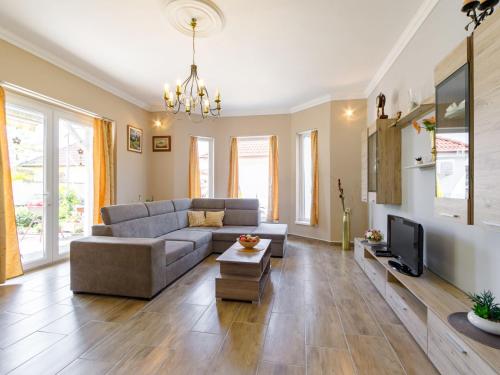 a living room with a couch and a tv at Holiday Home Ildiko by Interhome in Balatonlelle