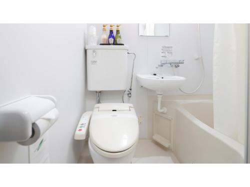 a white bathroom with a toilet and a sink at HOTEL Nishikawaguchi Weekly - Vacation STAY 43465v in Saitama