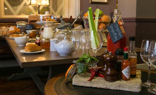 a table with wine glasses and food on it at Dog and Fox in London