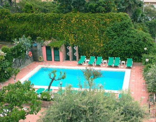 an overhead view of a swimming pool with lounge chairs at Hotel Villa Sirina in Taormina