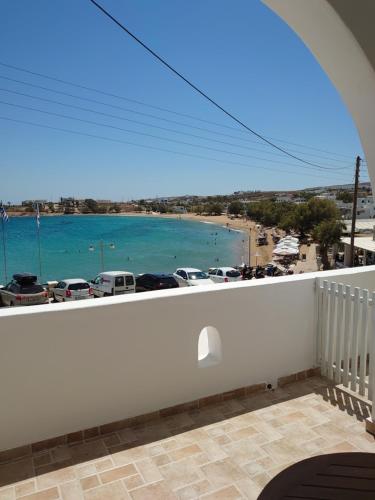 a balcony with a view of a beach at Annezina's memories in Logaras
