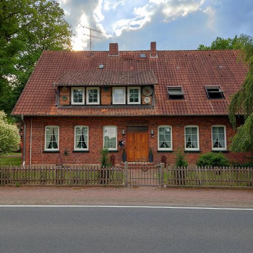 a red brick house with a brown roof at Röhrshof in Bispingen