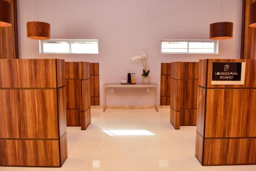 a row of wooden stalls in a room at Forte Express in Macapá