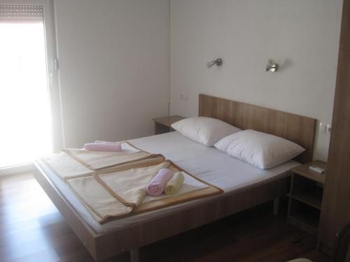 a bedroom with a bed with two towels on it at Rooms Ivan-Popić in Međugorje