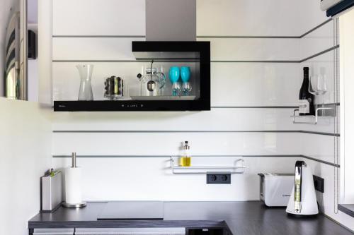 a kitchen with white walls and a counter with a sink at Sadama 4 Apartment in Pärnu