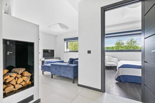 a room with a fireplace and a bedroom with a bed at Sadama 4 Apartment in Pärnu
