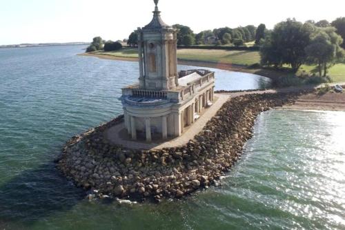 a clock tower in the middle of a body of water at Stamford Guest House in Stamford