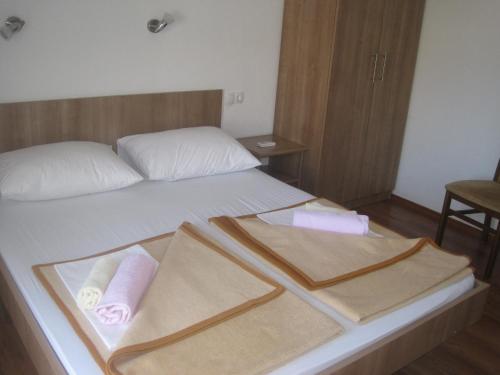 a hotel room with a bed with two towels on it at Rooms Ivan-Popić in Međugorje