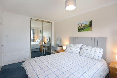 a bedroom with a bed and a desk with a computer at Ideal Central Edinburgh location with free on-site private parking in Edinburgh