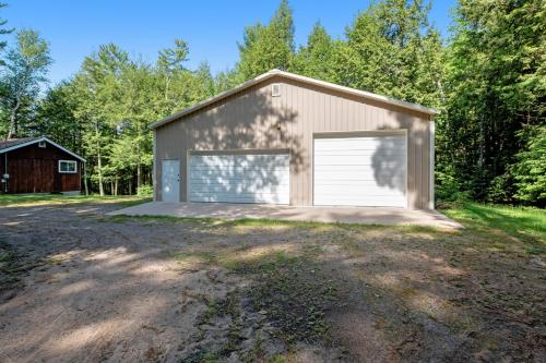 a garage with a large white garage door at Quaint Lake Escape in Eagle River